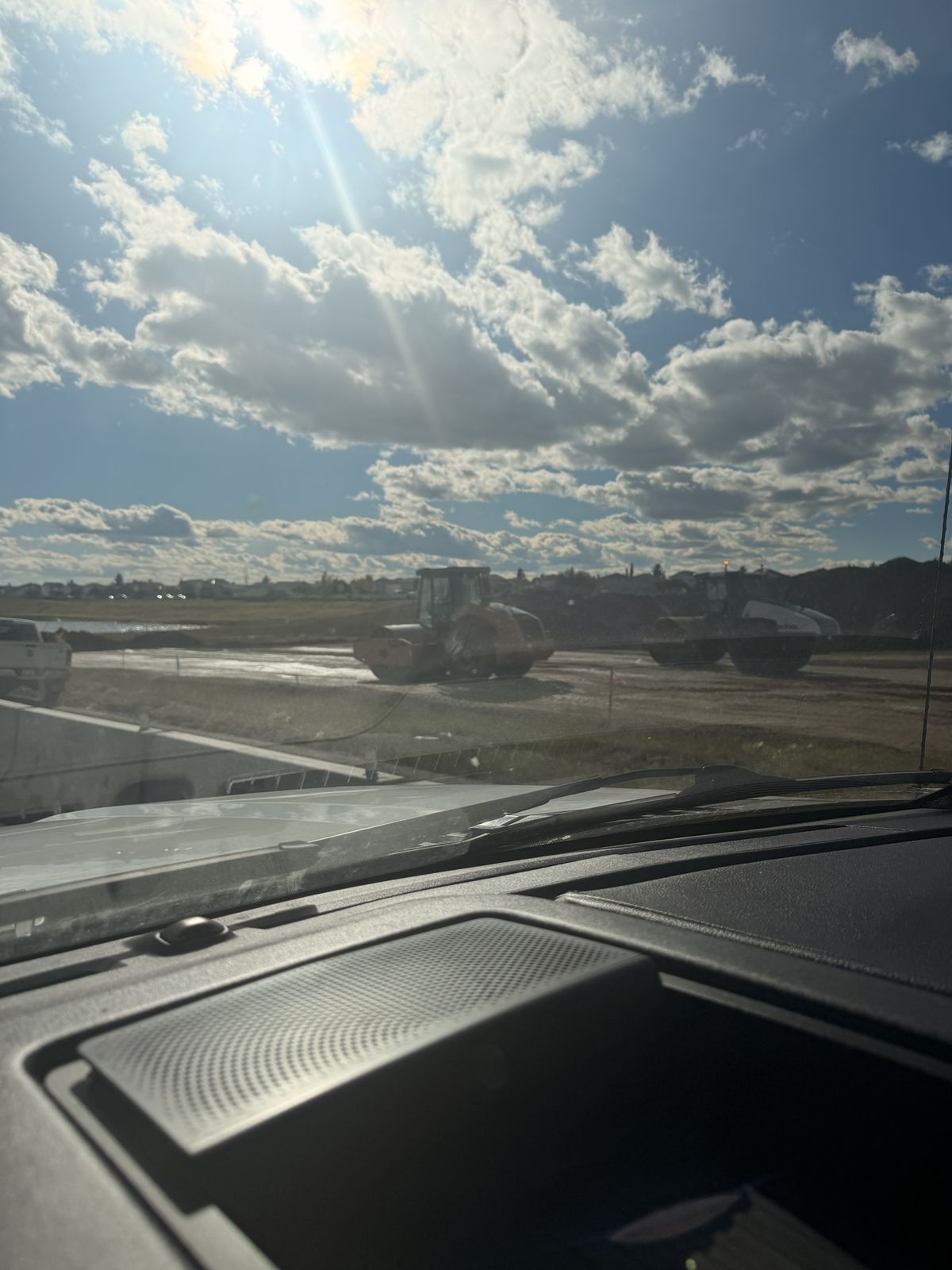 Road rollers compacting ground for Memorial Drive extension near Abbeydale, Calgary